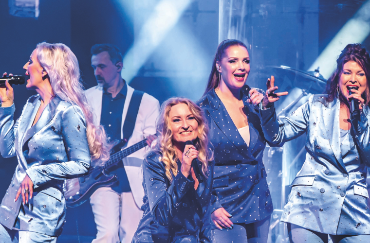 ABBA The Music tributeshow met performers in gouden kostuums, zingend en dansend op bekende ABBA-klassiekers in Castellum Theater & Film